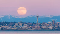 Moonrise over Seattle's Space Needle and the Cascade Mountains