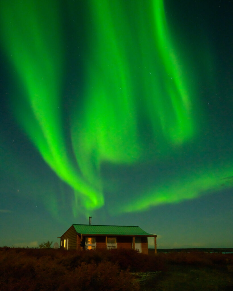 Northern Lights over cabin at Ennadai Lake