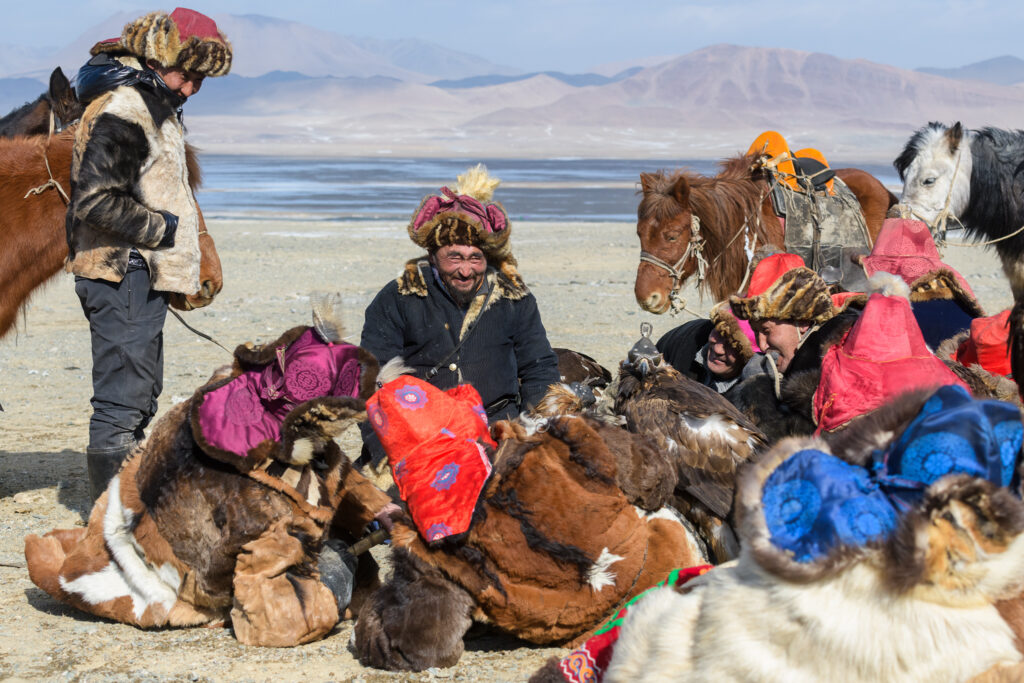 Group of eagle hunters chats during an eagle festival
