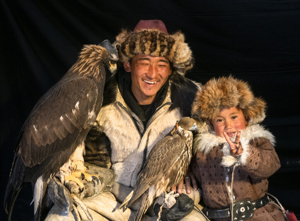 An Eagle hunter with his son poses for us in Mongolia