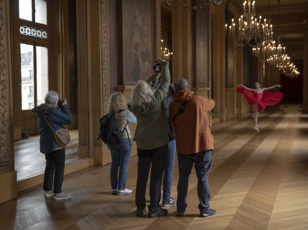 Photographers photograph a ballet dancer in the Palais Garnier