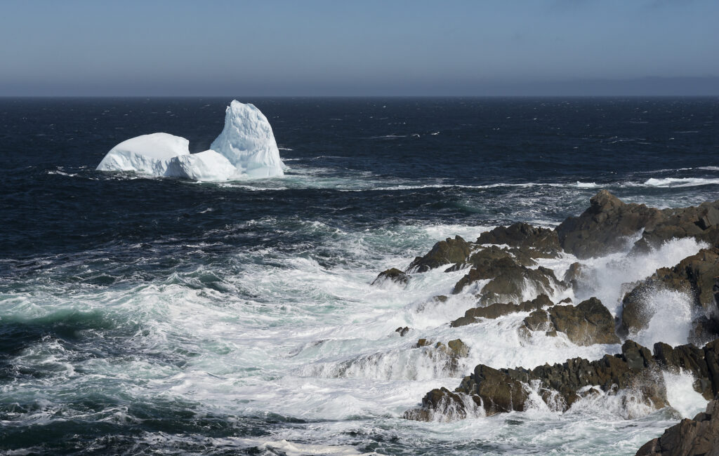 Bonavista lighthouse iceberg with crashing waves in the foreground