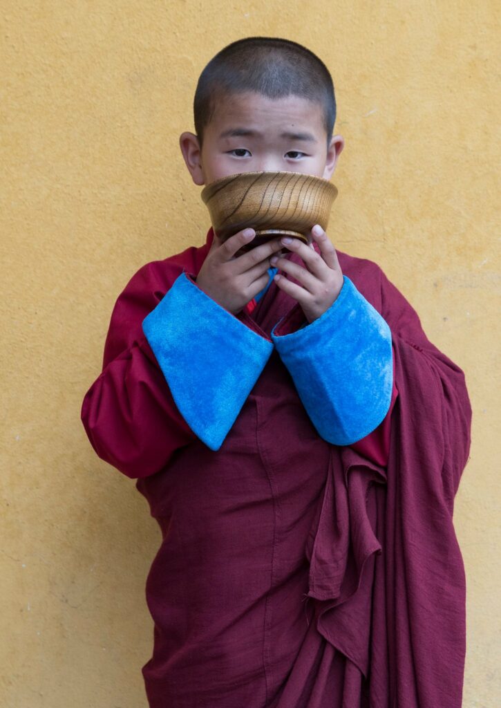 Young monk drinking tea