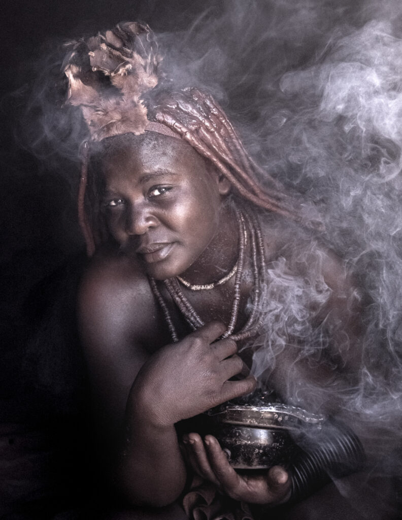 Himba woman having a smoke bath